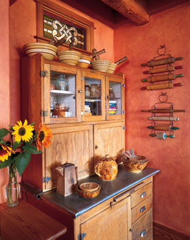 Andrea inherited this kitchen hutch from her grandmother and remembers what was kept in every drawer when she was young. (The gingersnaps were in the lower righthand drawer.) An antique lover, she began collecting rolling pins when she discovered one with a patina that stops dough from sticking to it. “It’s the stories that I love—whose birthday celebration pie was made using this?’’ she says. The kitchen walls are hand-rubbed in mango and cantaloupe shades. “To me, these are kitchen colors—warm and earthy, very alive,’’ Andrea says.